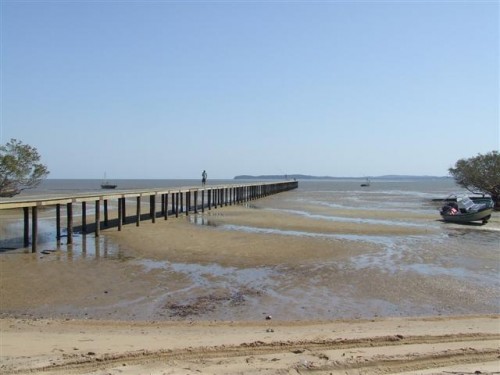 wooden pier at santa maria village during low tide