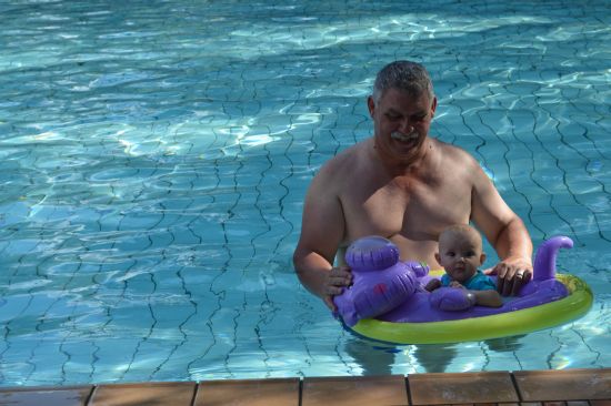 Oupa taking the little one for her first swim.jpg