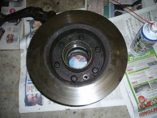 Front brake disk with the two retaining bolts removed.JPG