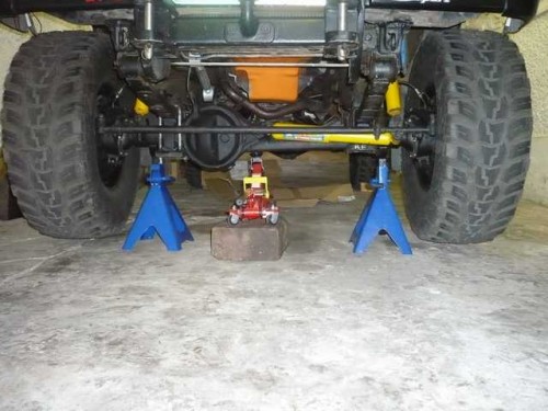 Front axle on jack stands to set steering stops.JPG