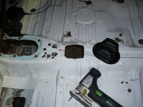 Cutting out the gearstick hole with a jigsaw.JPG